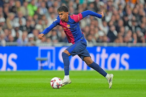 Lamine Yamal dribbling past defenders for Barcelona